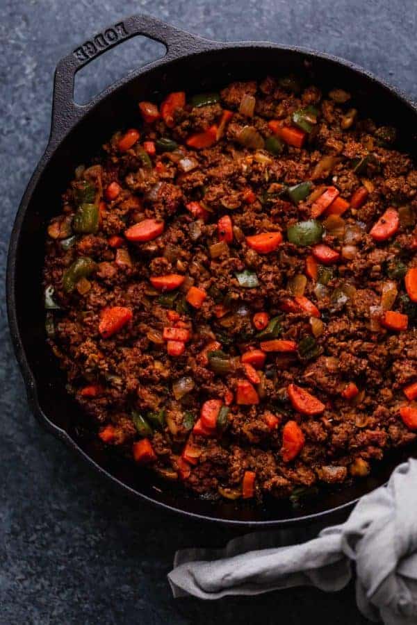 Photo of Shepherd's Pie filling in a cast iron dish.