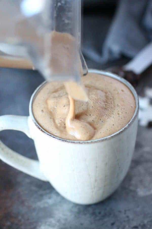 Gut Healing Cinnamon Coconut Latte being poured into a mug