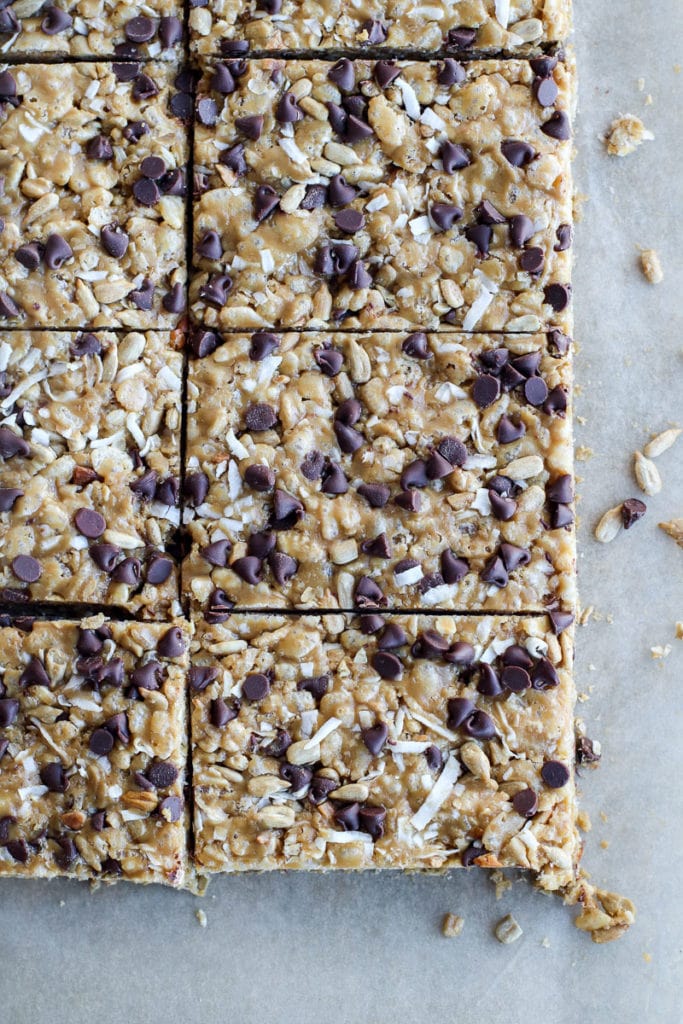 Freshly cut chocolate chip granola bars on a piece of parchment paper