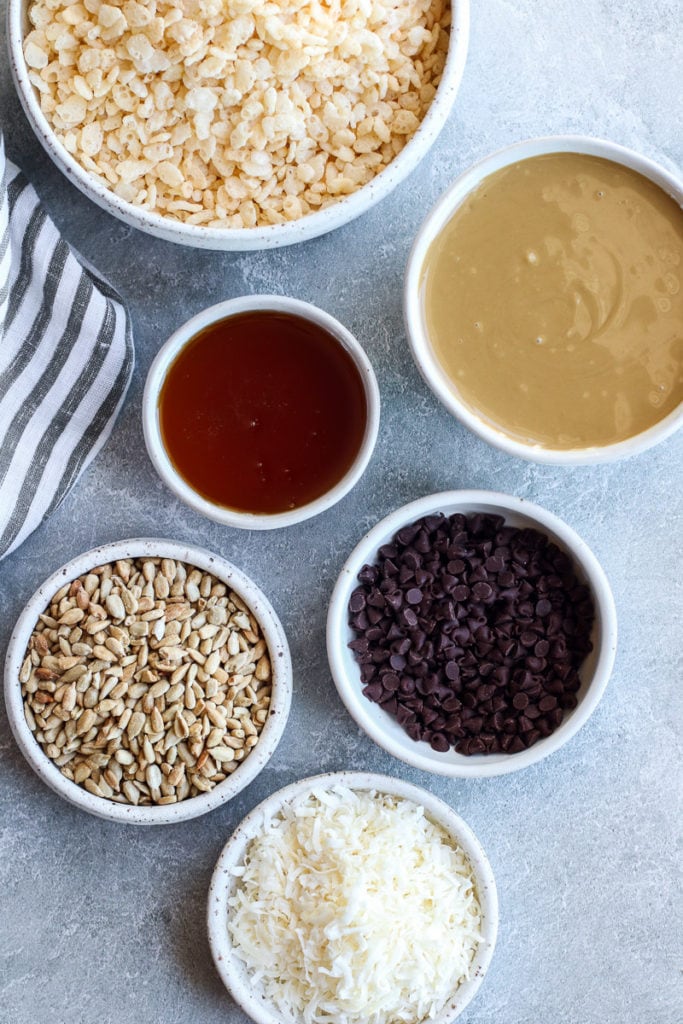 All ingredients for Crispy Chocolate Chip Granola Bars in small white bowls.