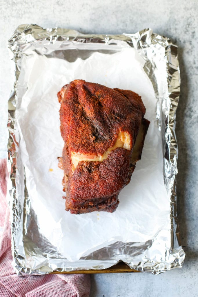 Freshly smoked pork butt on a foil covered baking sheet