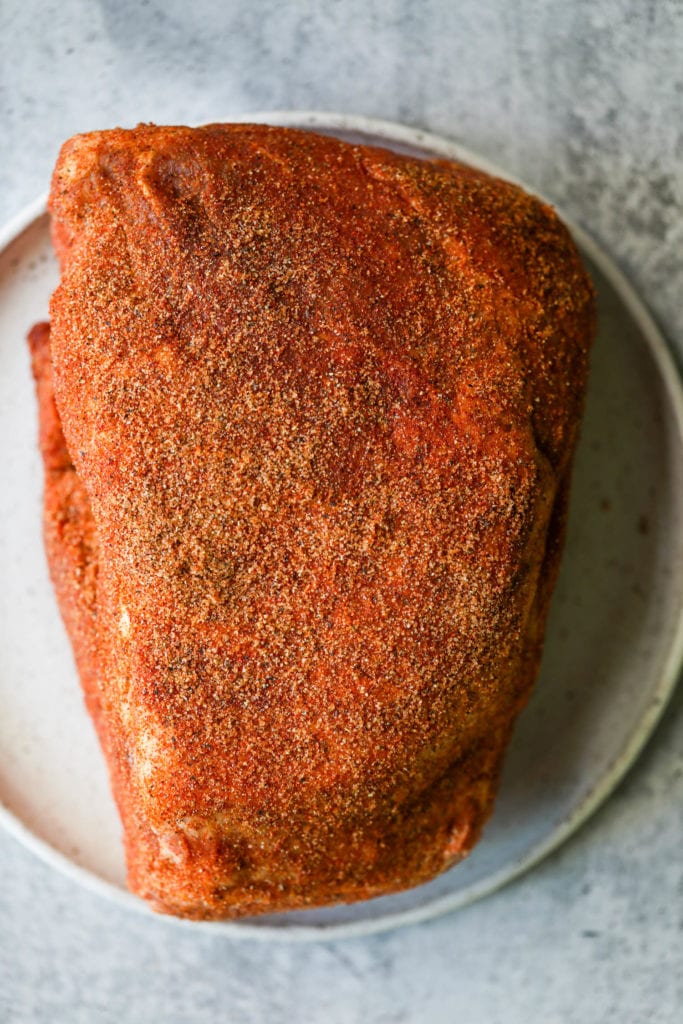 A large pork butt heavily seasoned with a homemade seasoning blend