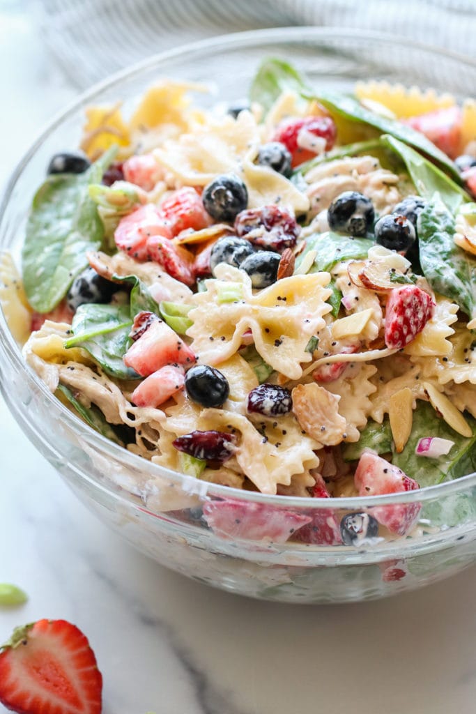 Summer Pasta Salad in a large, glass bowl, all tossed and ready to be served.
